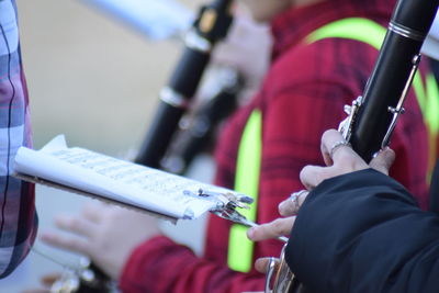 People holding paper outdoors