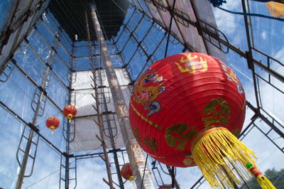 Low angle view of lanterns hanging by building