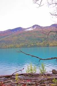 Scenic view of lake by mountains against clear sky