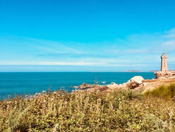 Scenic view of sea against blue sky