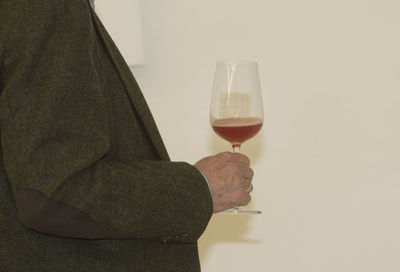 Close-up of man holding beer glass