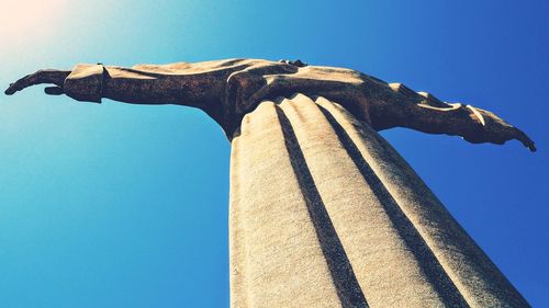 Low angle view of statue against clear blue sky