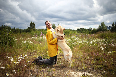 Woman with dog on field