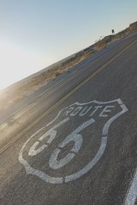 High angle view of sign on road against clear sky