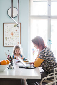 Women sitting on table at home