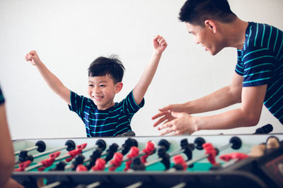 Family playing foosball at home