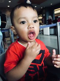 Close-up of cute boy with ice in mouth at restaurant