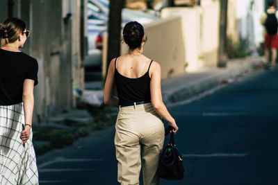 Rear view of women walking on street