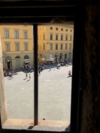 People on street by buildings in city