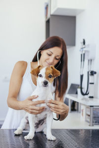 Veterinarian examining cute puppy in hospital