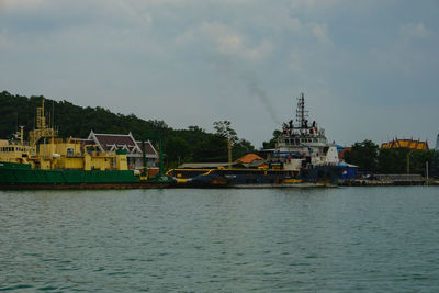 Scenic view of sea by buildings against sky