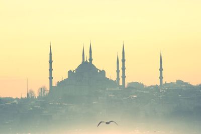 View of buildings in city against sky during sunset