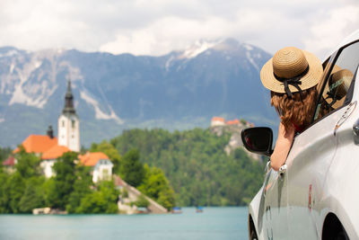 Rear view of woman wearing hat against mountain