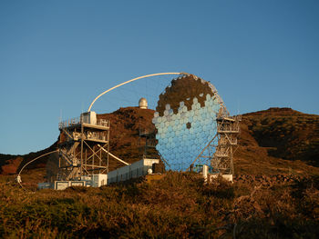 Various modern telescopes including magic or major atmospheric gamma imaging cherenkov telescope located on hill slope at astronomical observatory on island of la palma in spain