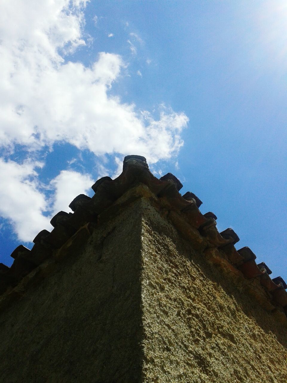 RUINS OF BUILDING AGAINST CLOUDY SKY