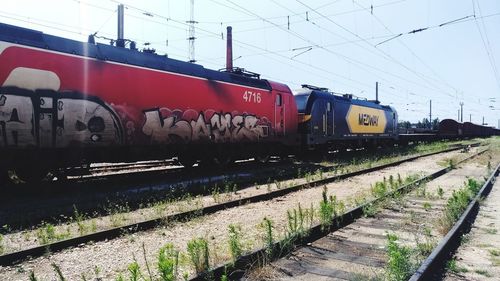 Train at railroad tracks against sky