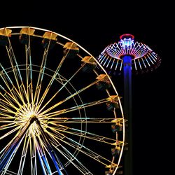 Low angle view of ferris wheel at night