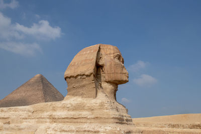 Low angle view of rock formations against clear blue sky