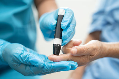 Midsection of doctor holding syringe