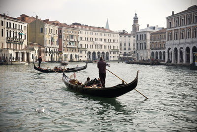 Rear view of man on boat in canal