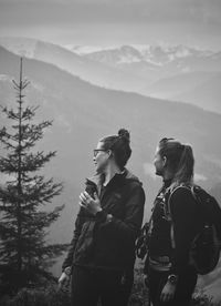 Female hikers looking at mountain