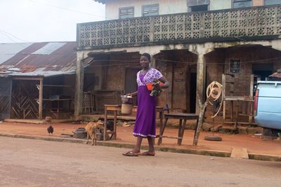 Woman standing against building