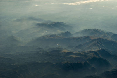 Scenic view of sea and mountains against sky