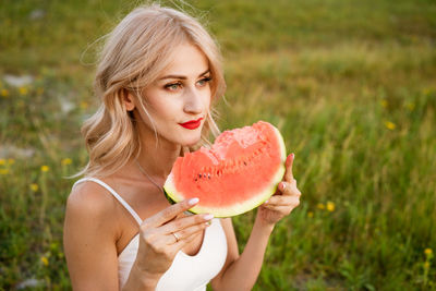 Portrait of woman eating fruit