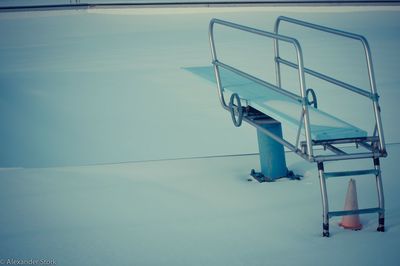 Diving platform over swimming pool