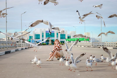 Asian woman striped shirt with seagull.