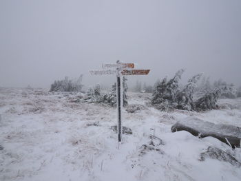 Snow covered road amidst field against sky during winter at the  brocken moutain, germany