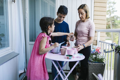 Mother with children on balcony