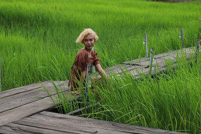 Portrait of woman standing on field