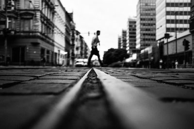 Man walking on road in city