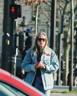 Portrait of woman wearing sunglasses standing outdoors