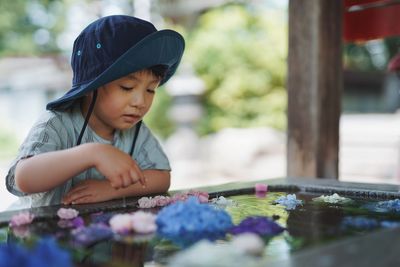 Portrait of cute girl painting on field