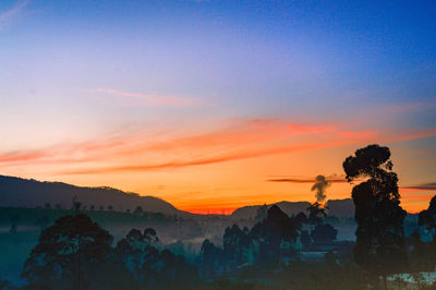 Scenic view of silhouette mountains against sky during sunset