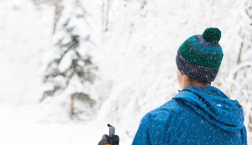 Rear view of man in snow