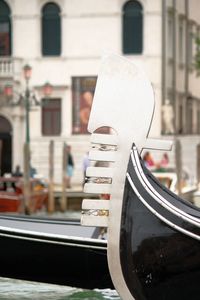 Close-up of gondola moored on grand canal 