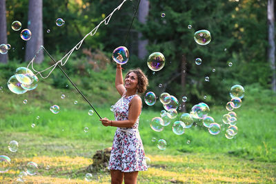 Full length of young woman in bubbles