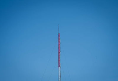 Low angle view of sailboat against clear blue sky