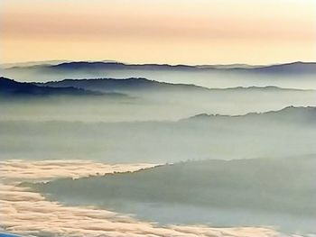 Scenic view of mountains against sky during sunset