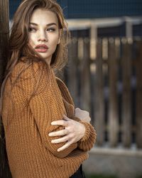 Portrait of beautiful young woman standing outdoors