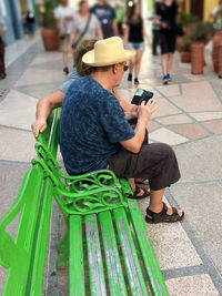 Woman holding mobile phone outdoors