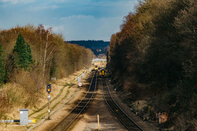 High angle view of railway tracks amidst trees against sky