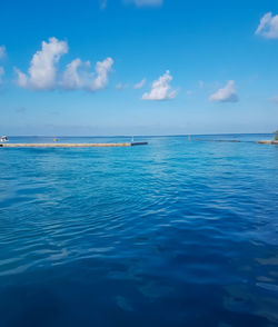 Scenic view of sea against blue sky