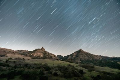 Scenic view of mountains against sky at night