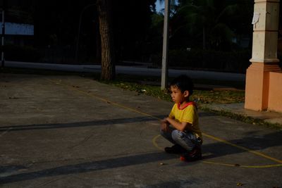 Boy sitting on road