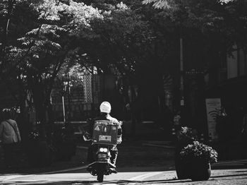 Rear view of people walking on street