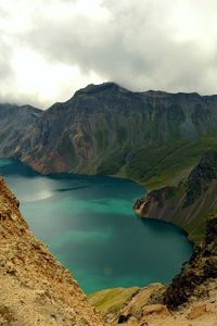 Scenic view of lake and mountains against sky